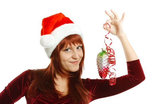 Beautiful girl in Santa hat with a decoration for the Christmas tree on a white background