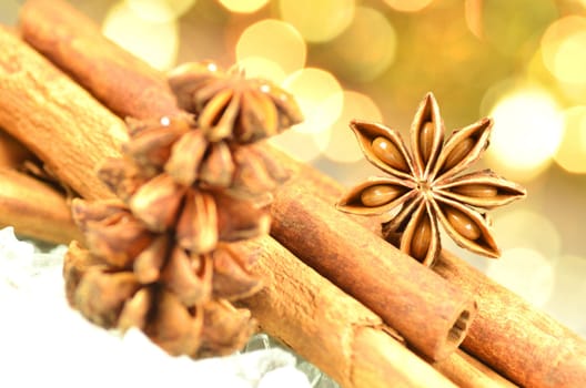 christmas season, cinnamon sticks, anise stars on bokeh background