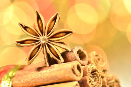 christmas season, cinnamon sticks, anise star on bokeh background