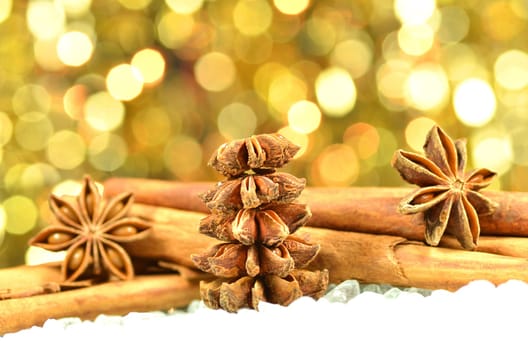christmas season, cinnamon sticks, anise stars on bokeh background