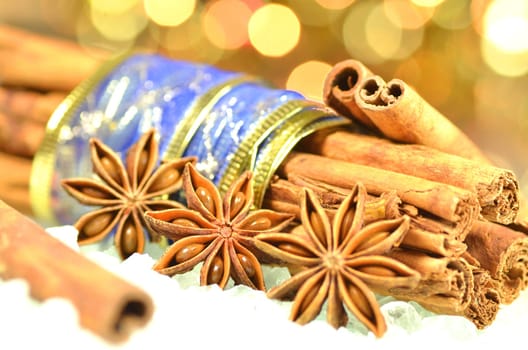 christmas season, cinnamon sticks, anise stars on bokeh background