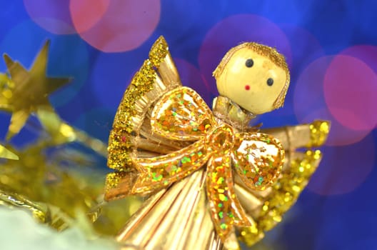 christmas decoration, angel made of straw and bokeh background
