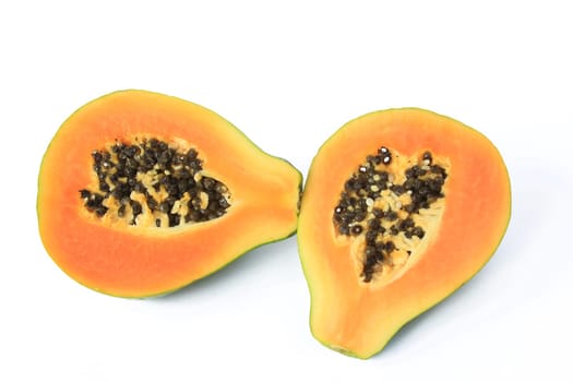 ripe papaya fruit (Carica Papaya),halved and exposed against a white background