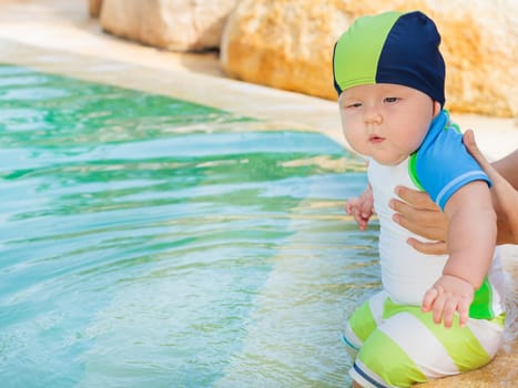 Adorable baby in swimming pool