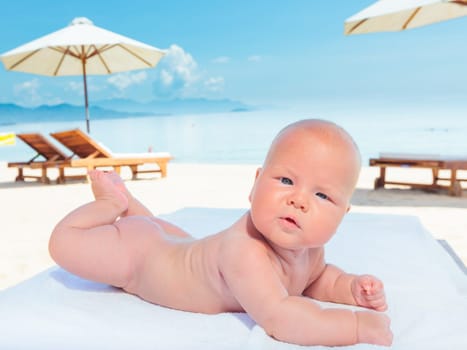 Cute baby laying on the sunbed at the beach