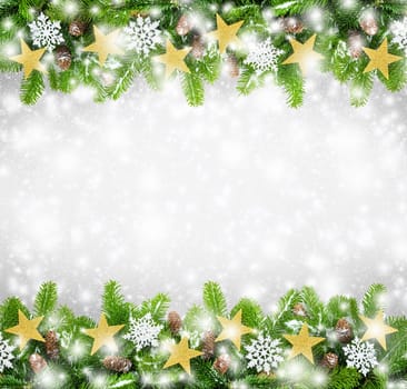 Decorated fir branches on a light background with snowflakes