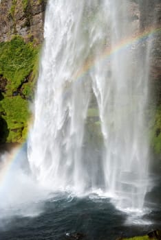 Seljalandsfoss waterfall with rainbow in Iceland