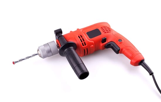 Orange electric drill with handle isolated on white background.