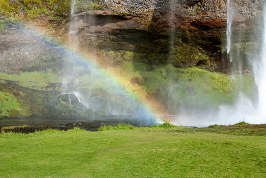 Seljalandsfoss waterfall with rainbow in Iceland
