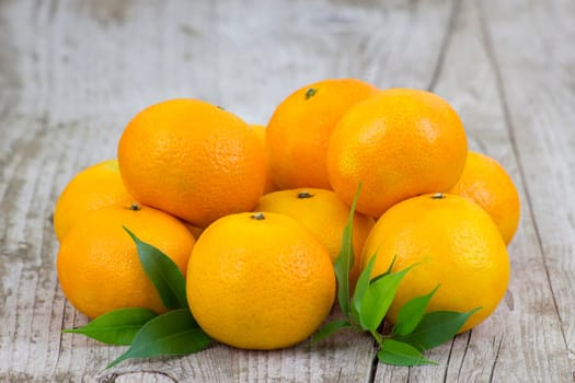 fresh tangerines on old wooden background