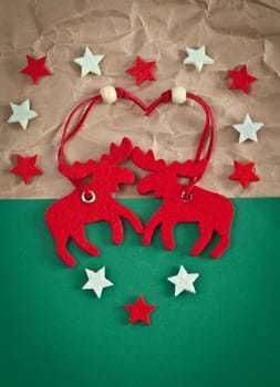 Red elk made of felt on a green background