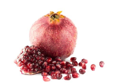 Ripe pomegranate fruit and part isolated on white background .