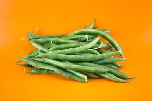 fresh beans fruit on orange background .