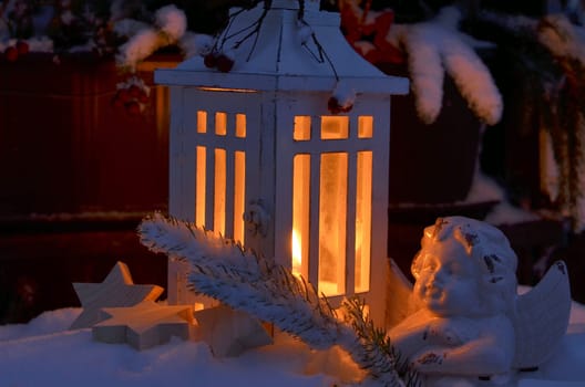 Lantern in the snow contemplative Christmas candlelight