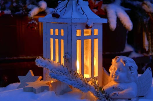 Lantern in the snow contemplative Christmas candlelight