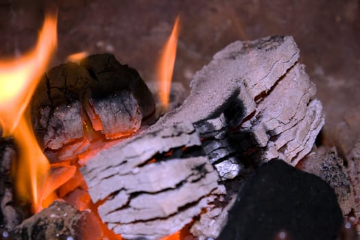 peat briquettes burning in a red and white hot fire