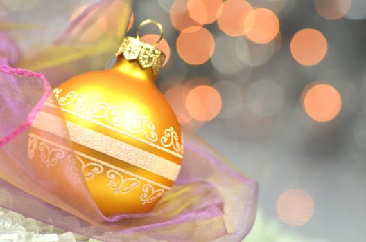 christmas decoration, golden Christmas ball against bokeh background