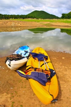 Kayaks, canoe  on the edge of the water in Lake Dam Kaeng Krachan, Thailand