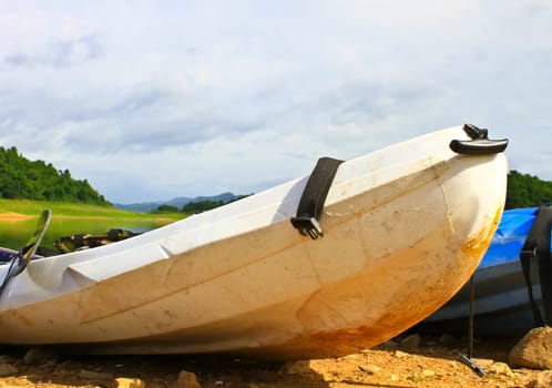 Kayaks, canoe  on the edge of the water in Lake Dam Kaeng Krachan, Thailand