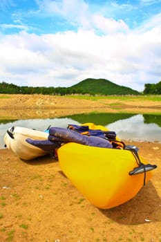 Kayaks, canoe  on the edge of the water in Lake Dam Kaeng Krachan, Thailand