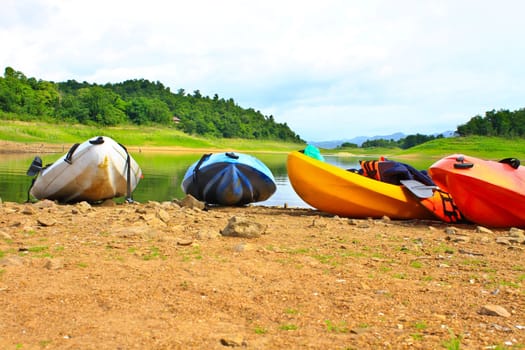 Kayaks, canoe  on the edge of the water in Lake Dam Kaeng Krachan, Thailand