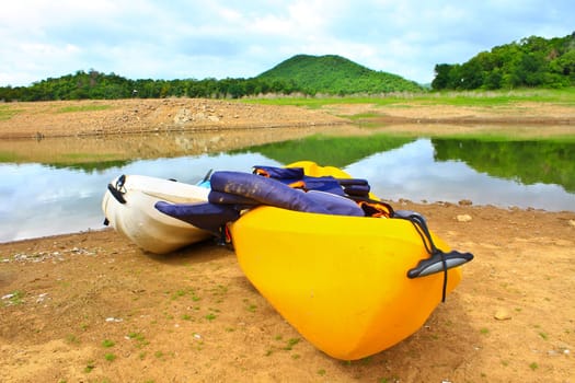 Kayaks, canoe  on the edge of the water in Lake Dam Kaeng Krachan, Thailand
