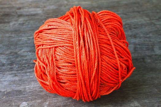 Bunch of red nylon rope on a wooden background