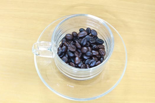 coffee beans in cup on the wood table