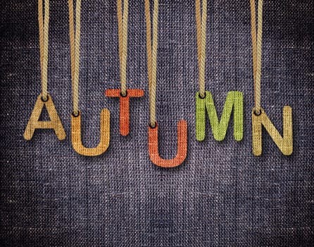 Autumn letters hanging strings with blue sackcloth background.