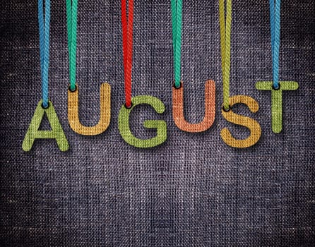 August letters hanging strings with blue sackcloth background.