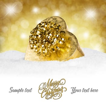 Golden gift on snow in front of a golden background