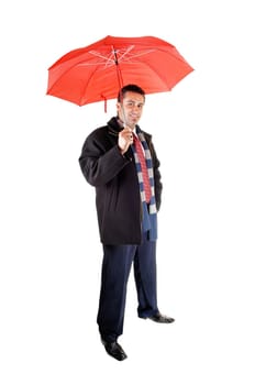 A young tall man in a black coat standing in the studio, holding an.red umbrella, for white background..
