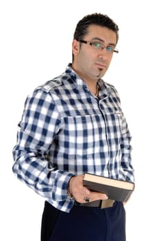 A young handsome man standing for white background very relaxed with a .book in his hands. .