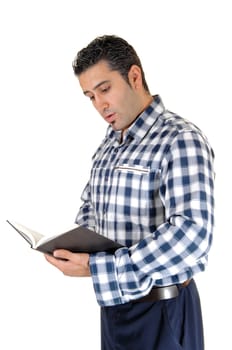 A young tall man standing for white background very relaxed with a book.in his hands and reading..