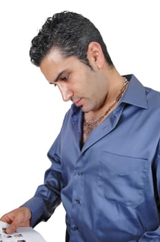 A young man in a blue shirt standing whit some paper in his hand.looking down and thinking, for white background..