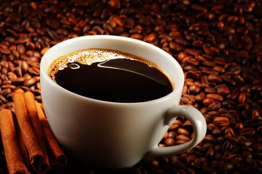 Composition with cup of coffee and beans