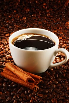 Composition with cup of coffee and beans