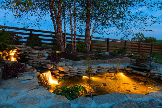 Decorative koi pond in a garden at night