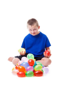 Boy with a pile of water balloons isolated on white background
