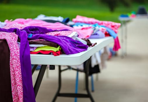 Clothes laid out on a table at a garage sale
