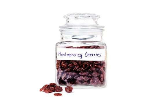 Glass jar with dried Montmorency cherries isolated on white background