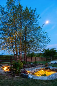 Decorative koi pond in a garden at night