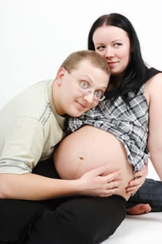 Young happy couple. Husband and pregnant wife. studio photography