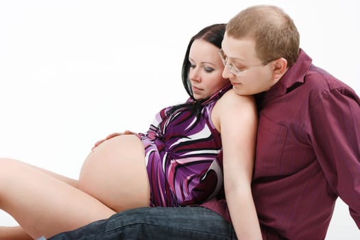 Young happy couple. Husband and pregnant wife. studio photography