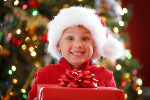 happy boy holding Christmas present