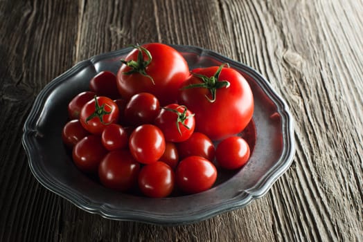 Fresh ripe tomatoes on wooden background close up