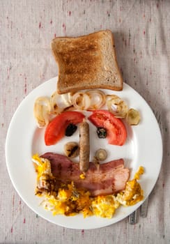 Funny face made from ingredients of English breakfast