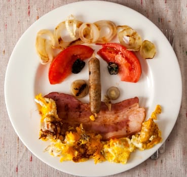 Funny face made from ingredients of English breakfast