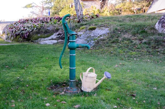 .Load an old watering can on an old water pump