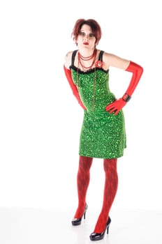 Young root-haired woman wears a green leopard-print mini dress with bright red tights and purple pumps,insulated against a white background.
